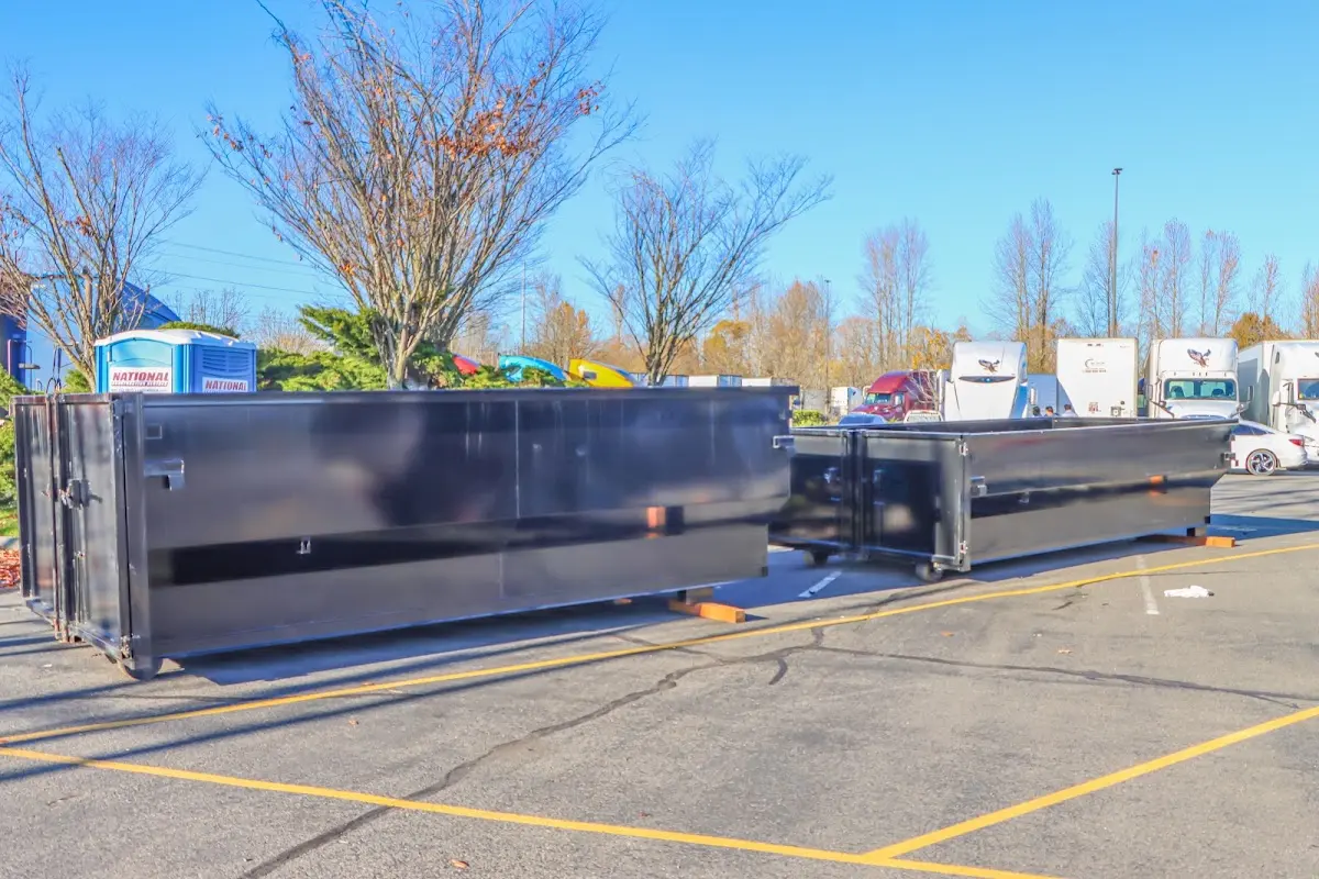 Professional dumpster rental service with roll-off container on residential driveway in Quincy